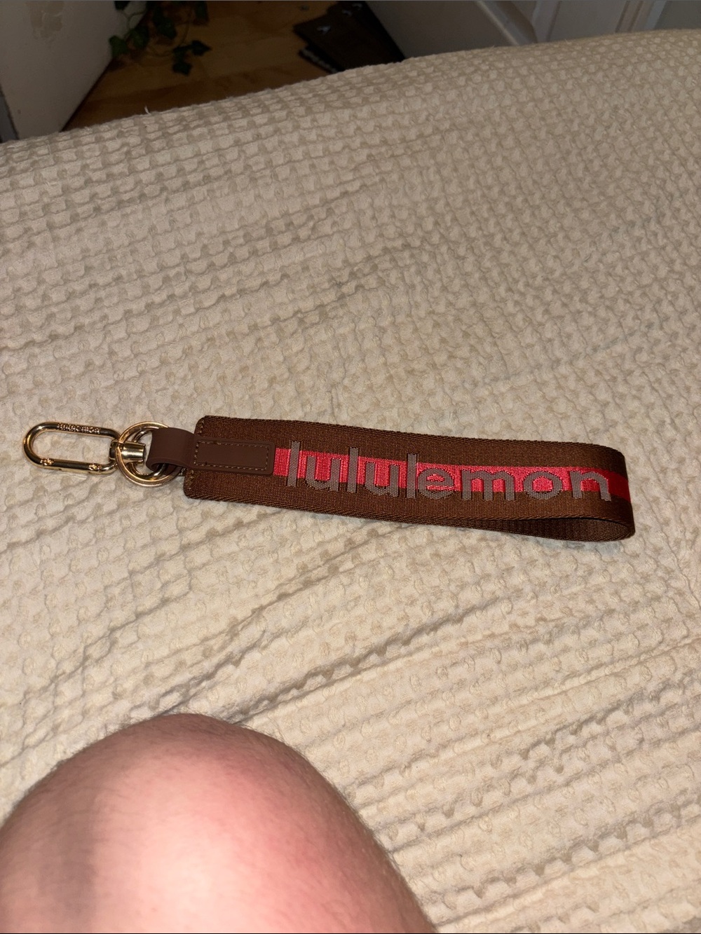 Lululemon brown and pink never lost key chain